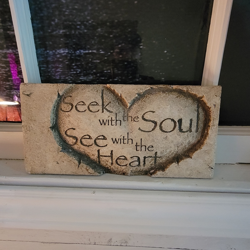 Inspirational plaque reading “Seek with the Soul, See with the Heart” sitting on the window ledge in The Zen Shop’s Reading Parlour