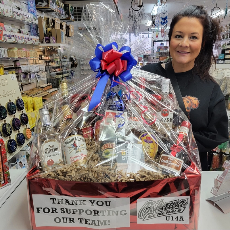 Fundraiser winner Bonnie receives $500 Booze Basket donated by The Zen Shop to raise funds for youth hockey team iPad and software.